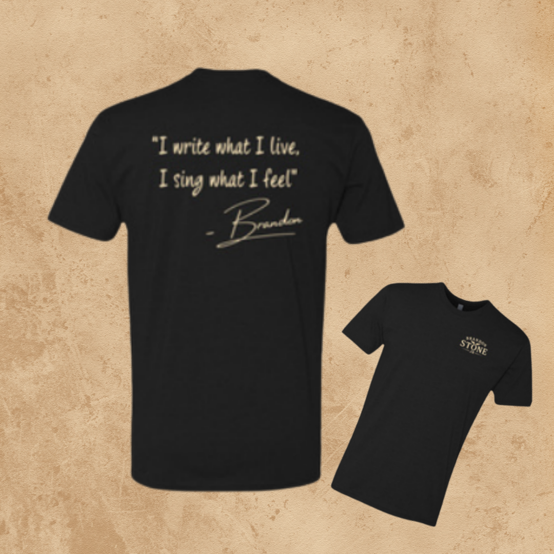 Front and back of the black Brandon Stone Jr. signature t-shirt: small left-chest logo on the front, and the quote “I write what I live, I sing what I feel” with Brandon's signature on the back