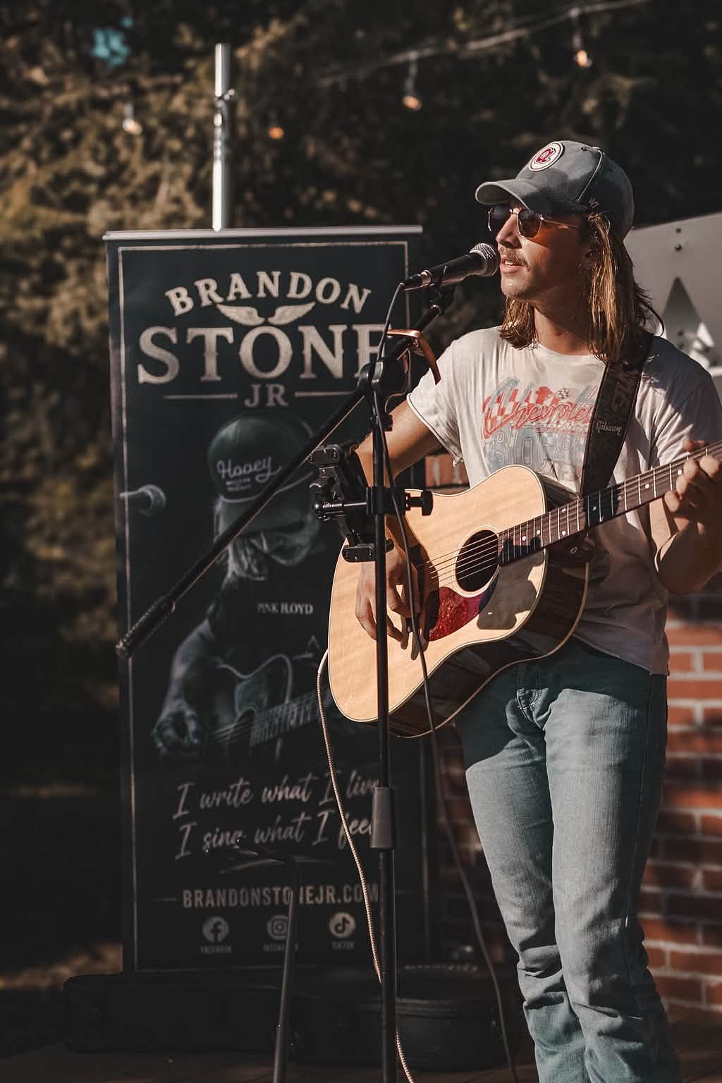 Brandon Stone Jr. performing live with his Brandon Stone Jr. banner behind him